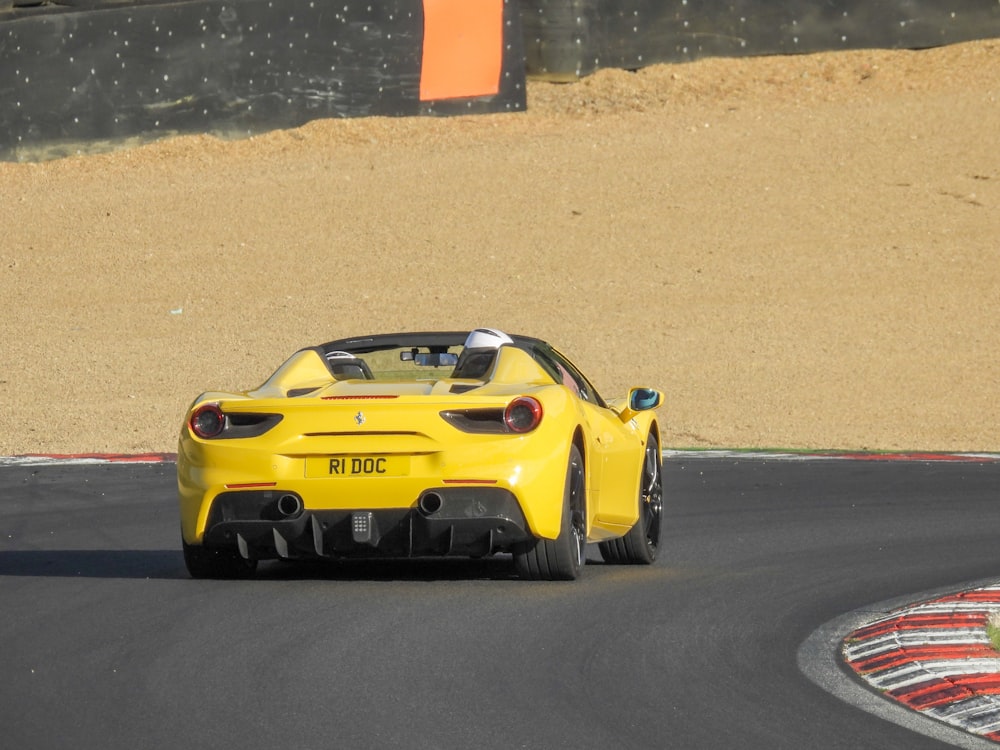 a yellow sports car on a track