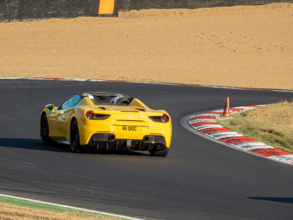 a yellow race car on a track