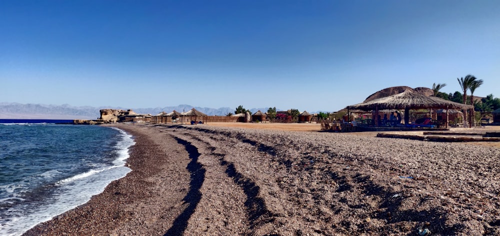 a sandy beach with huts