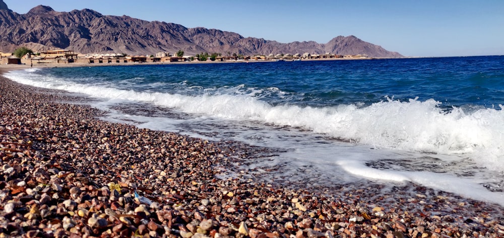 a rocky beach with waves crashing