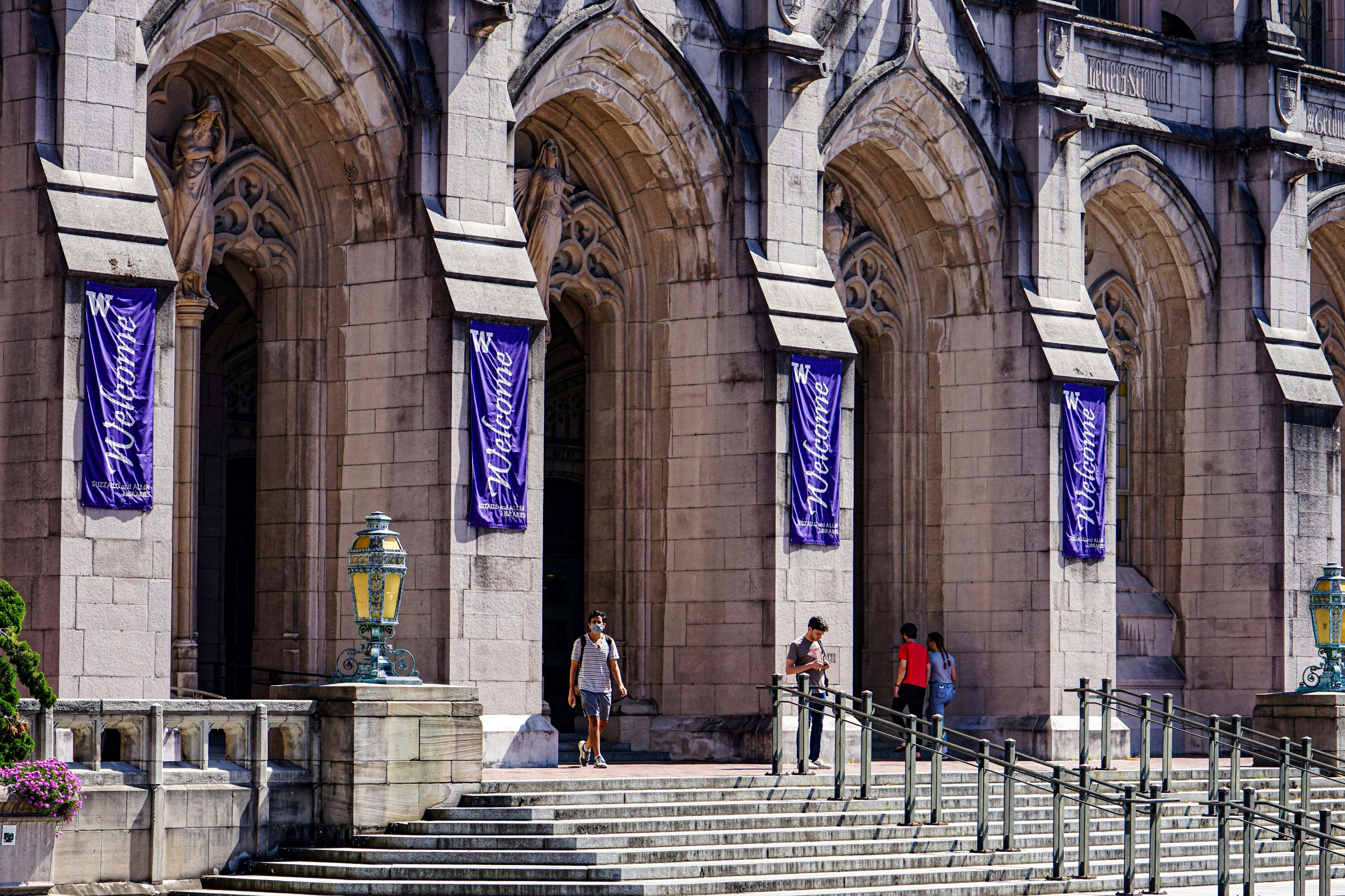 people walking up stairs to a building