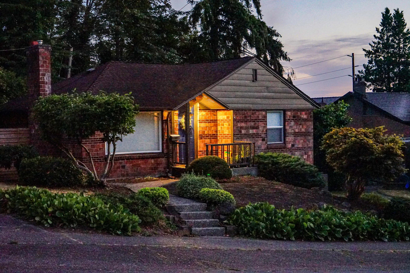 Seattle brick home on a large lot at dusk
