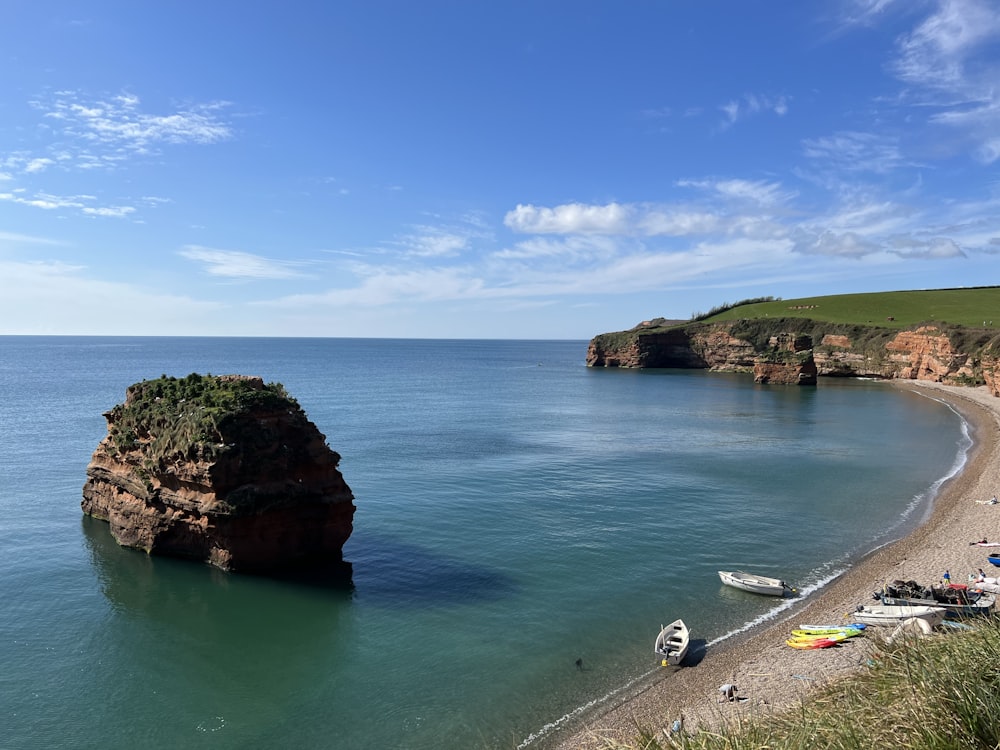 a beach with boats and a body of water