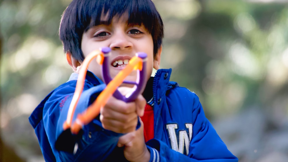 a boy holding a toy