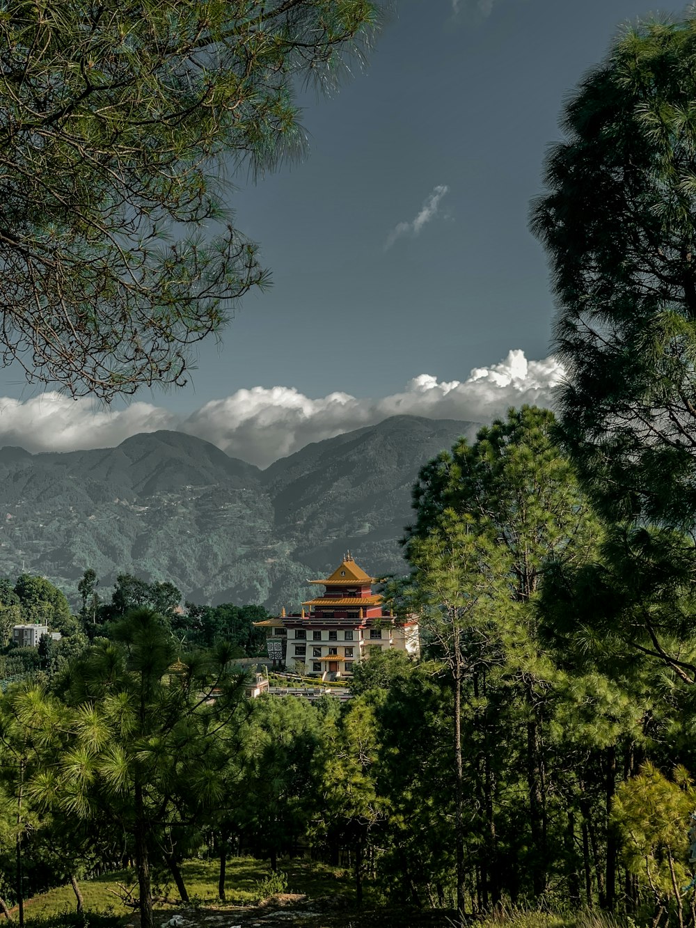 a building surrounded by trees and mountains