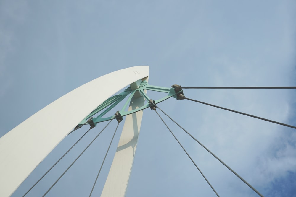 a white sailboat with a green sail