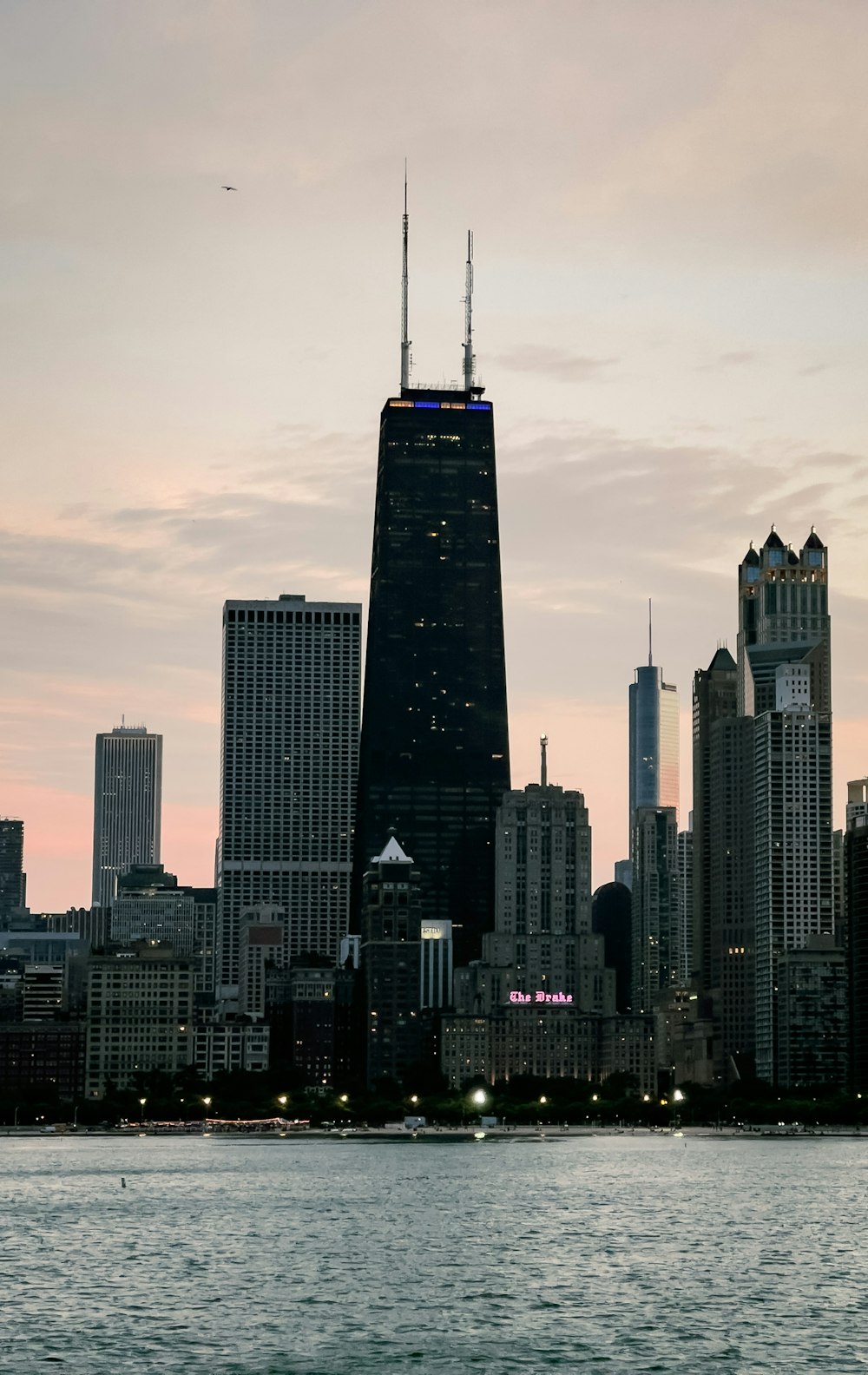 John Hancock Center skyline with a body of water in the foreground photo –  Free Chicago Image on Unsplash