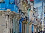a row of buildings with blue and green doors