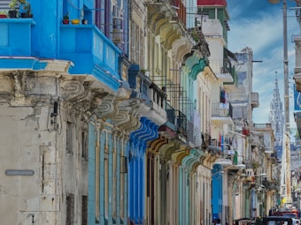 a row of buildings with blue and green doors