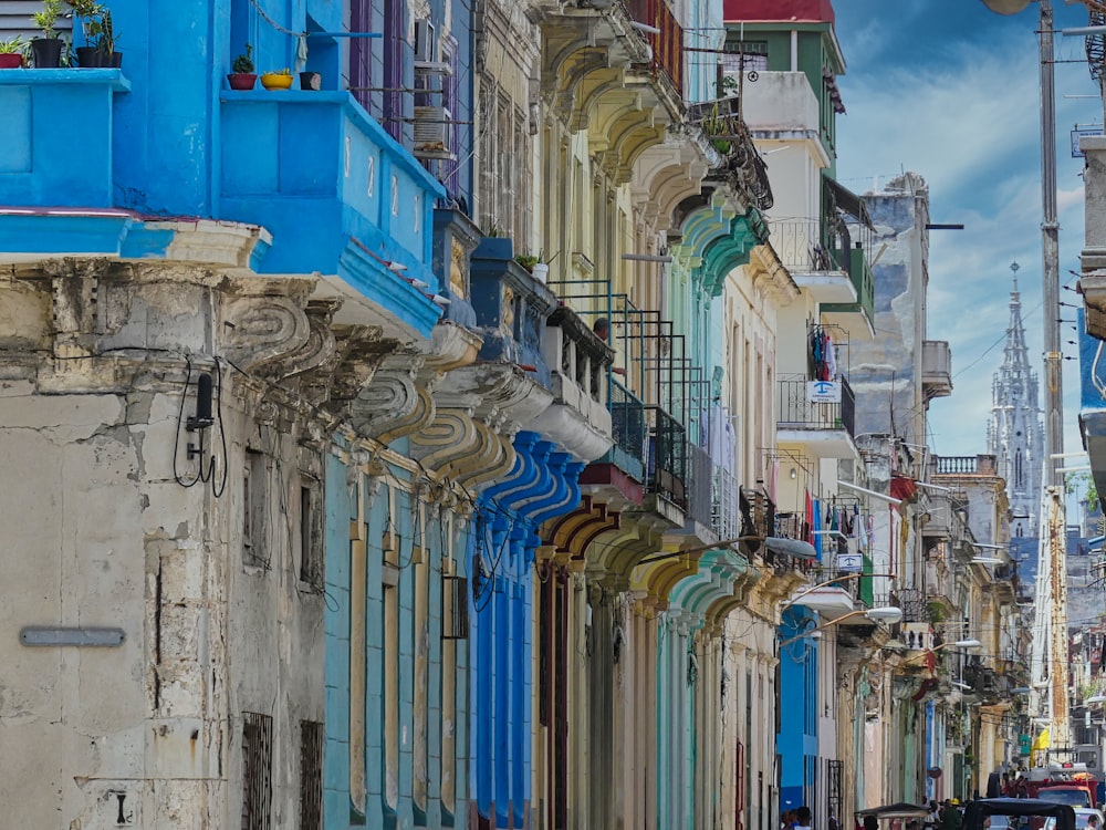 a row of buildings with blue and green doors