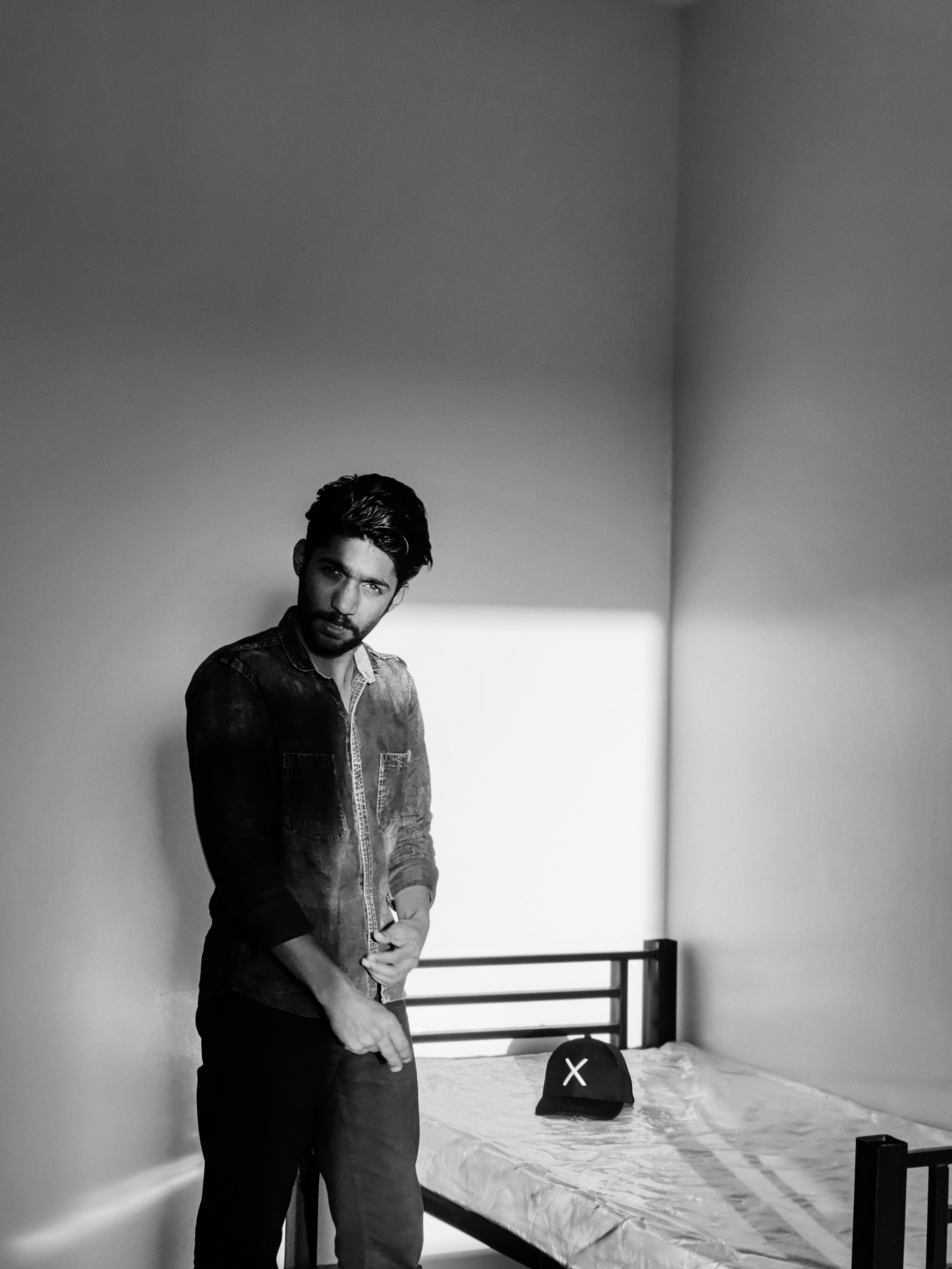 a person standing next to a bed