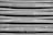 The image displays a close-up view of a corrugated metal surface with a slightly weathered and scratched appearance. There are a few bolts and fixtures visible along the bottom of the metal sheets.