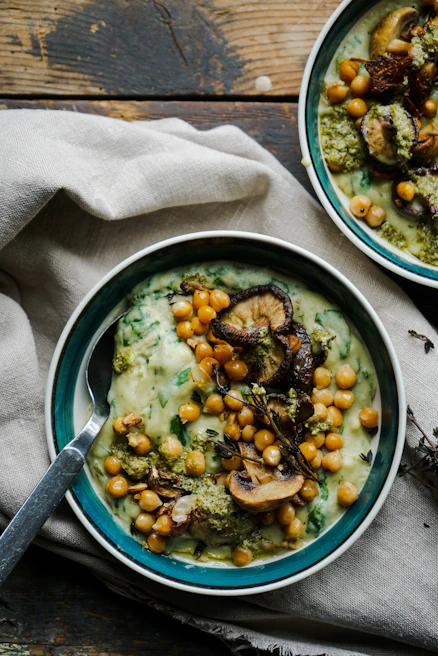 Close-up of a creamy lentil soup garnished with fresh herbs, steaming and inviting for a fast nutritious dish.