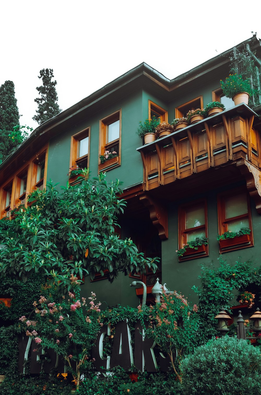 a house with trees and plants around it