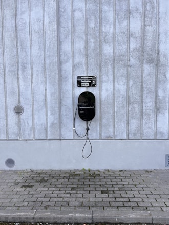 Technician installing a chemical earthing system beside a modern EV charging station.