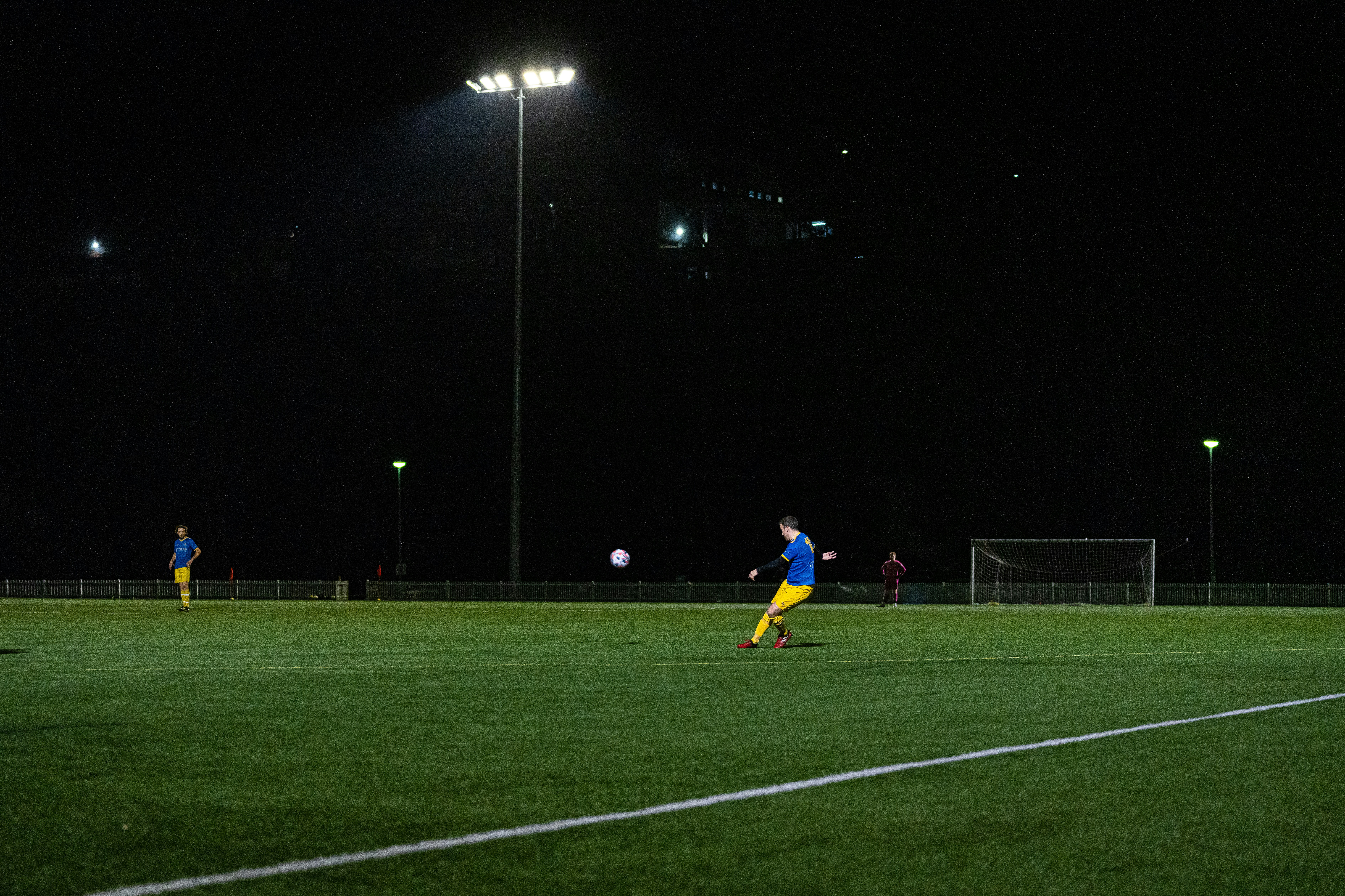 Person playing football at night