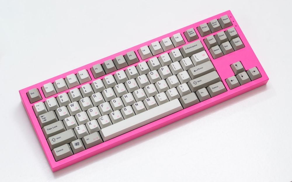 a pink keyboard with a white background