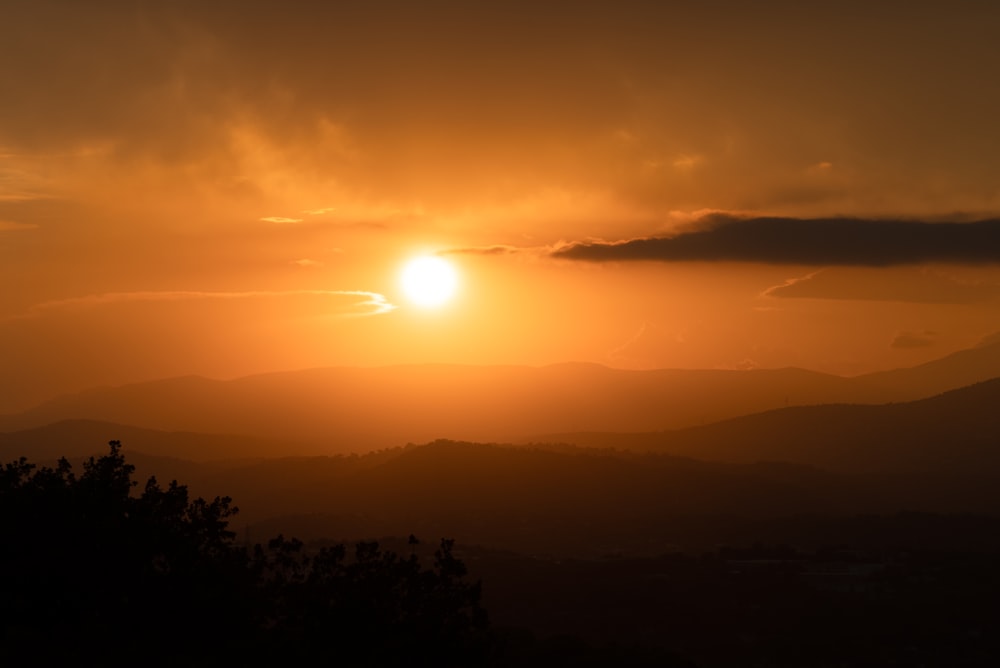 a sunset over a valley