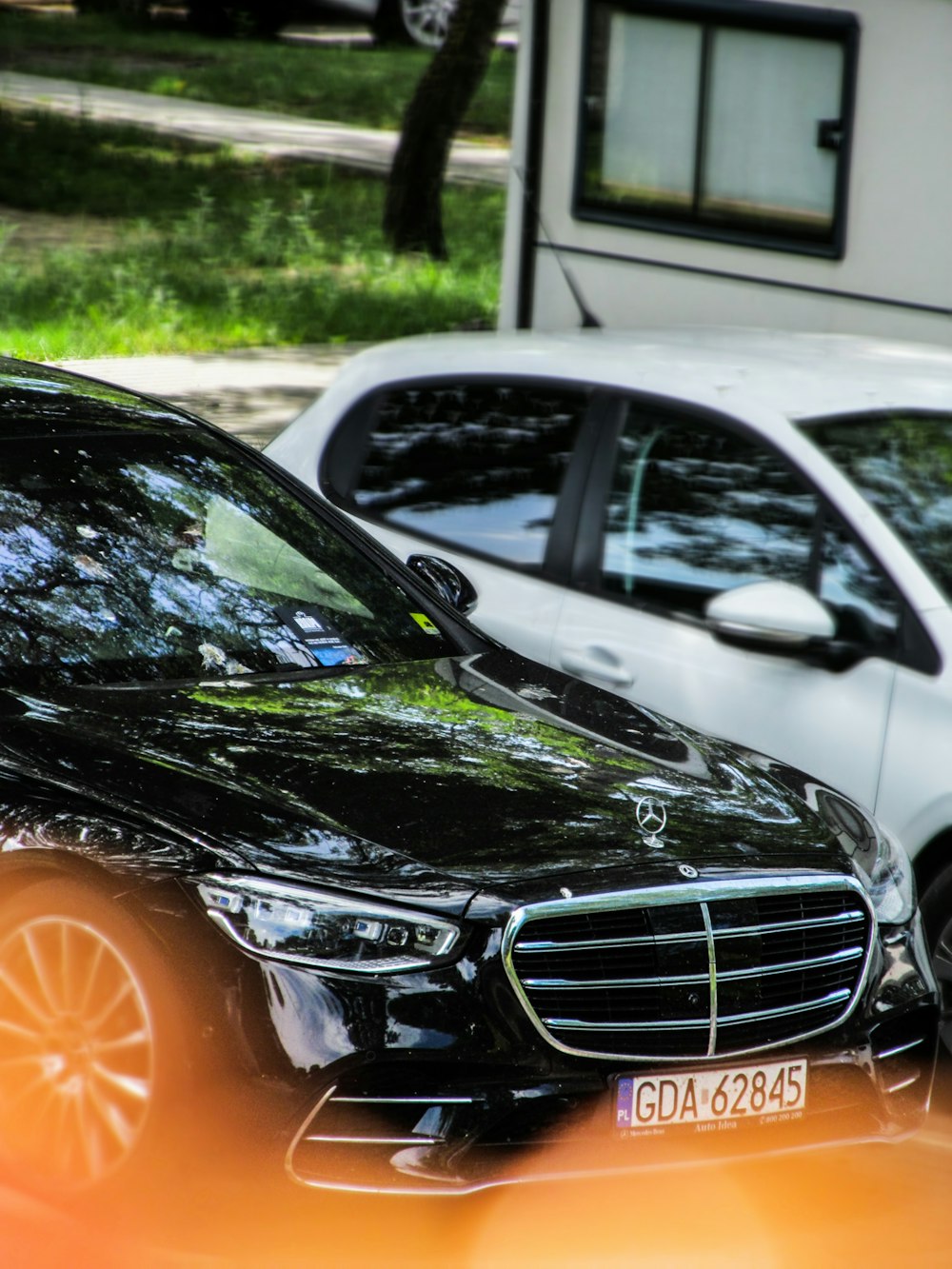 a black car parked in front of a house