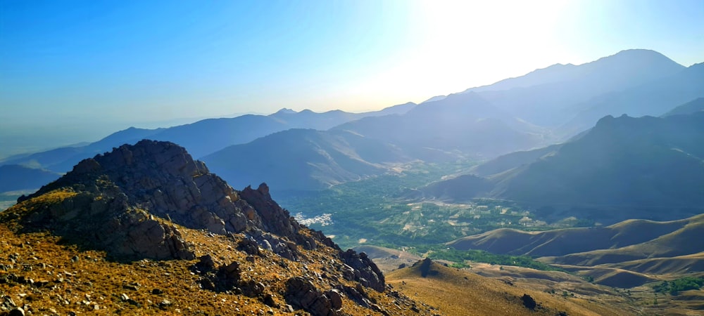 a valley with mountains in the background