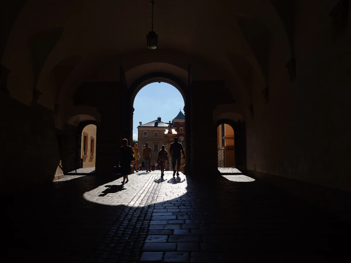 a group of people walking through a tunnel