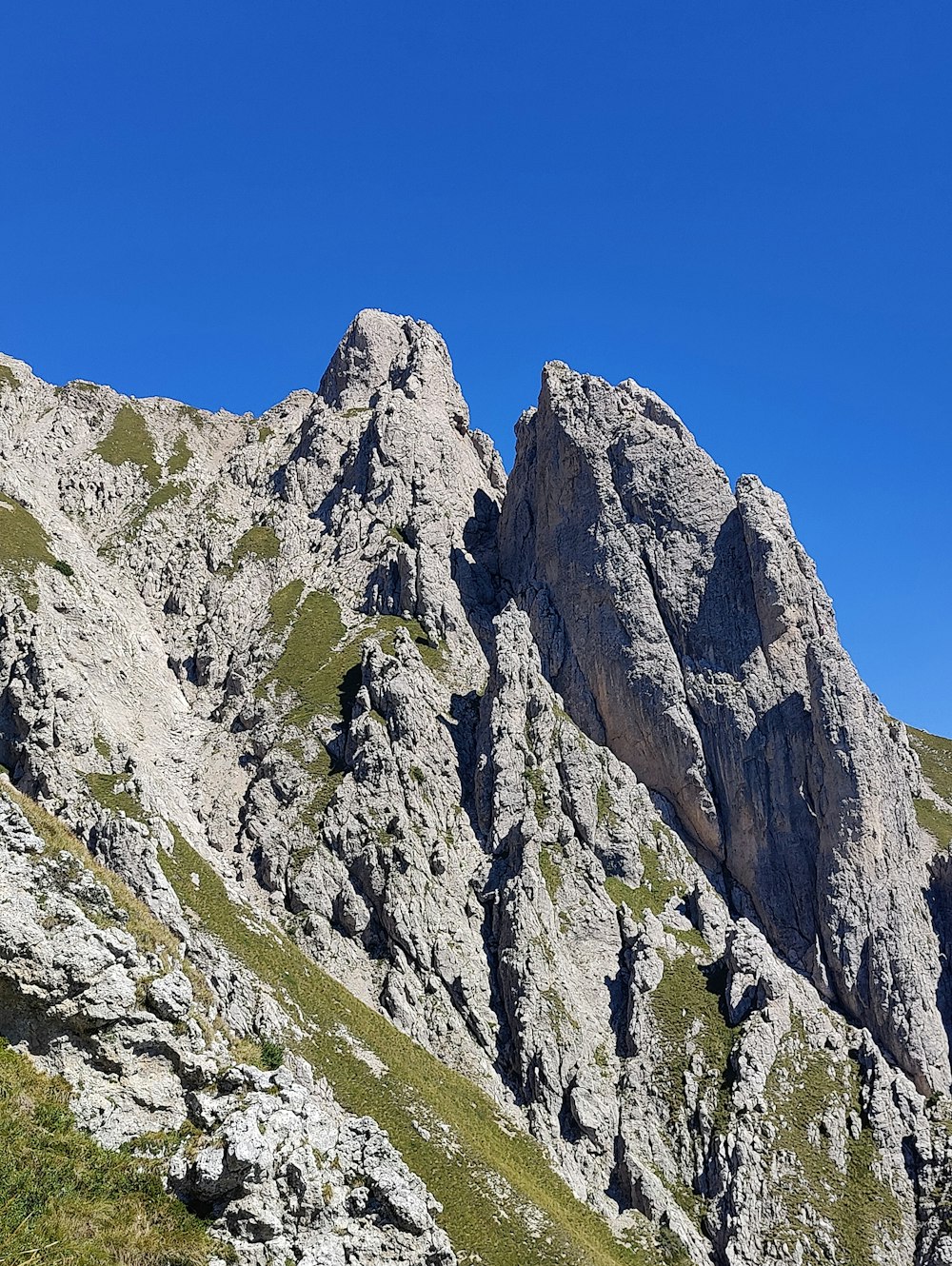 a rocky mountain with a blue sky