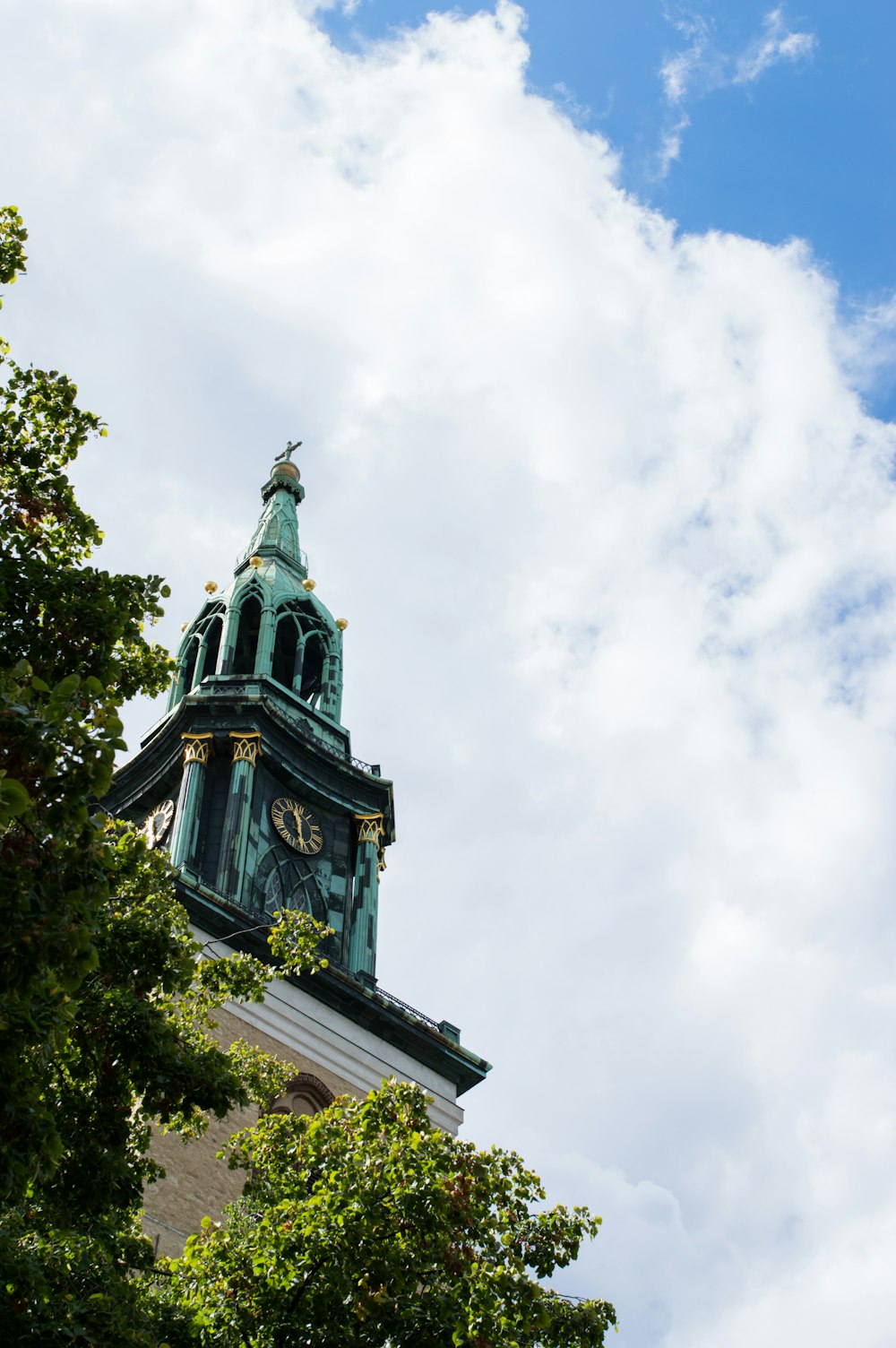 a clock tower with a statue on top