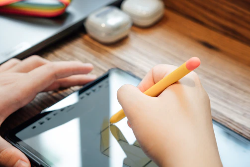 a person holding a yellow pencil