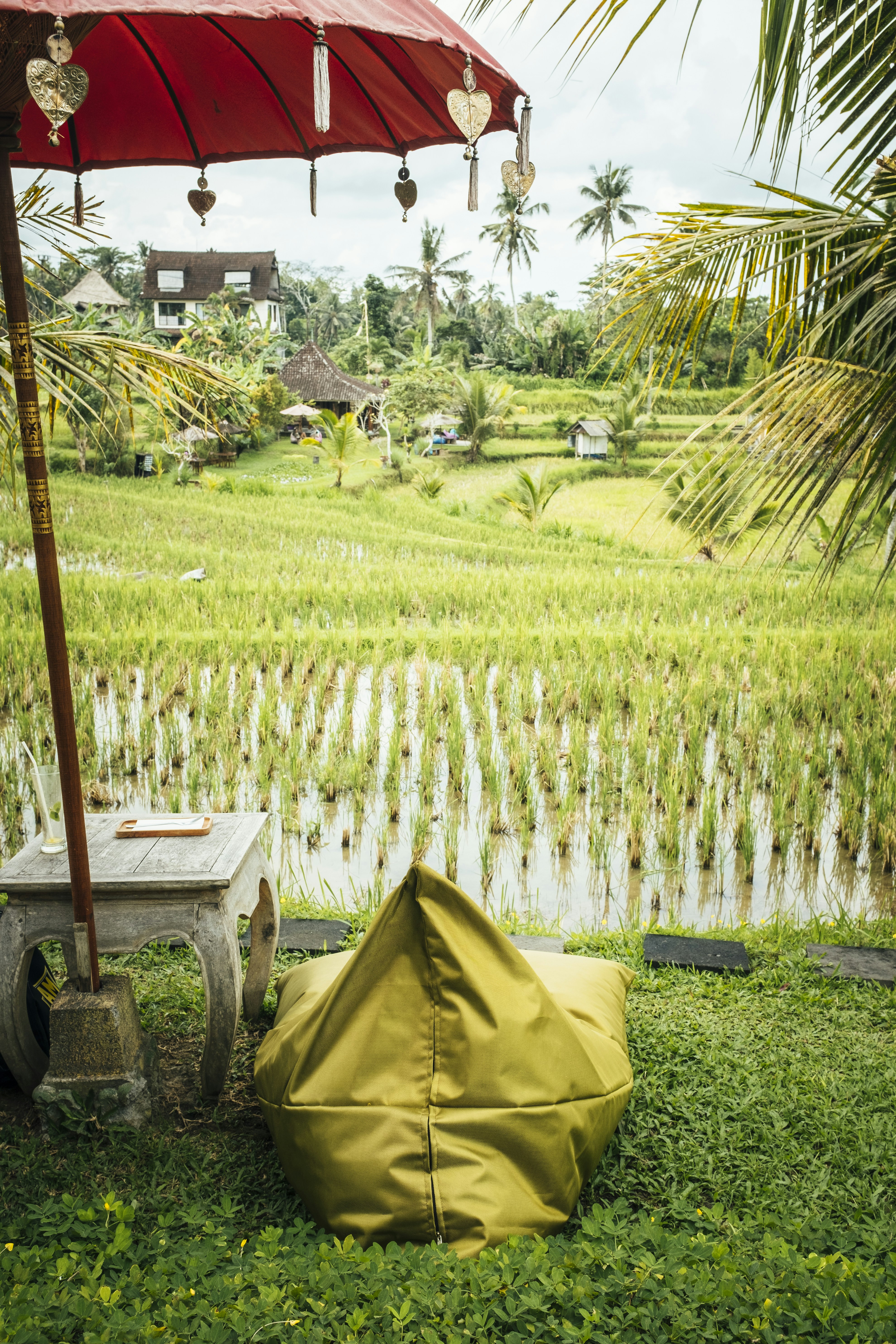 a yellow tent on grass by a body of water