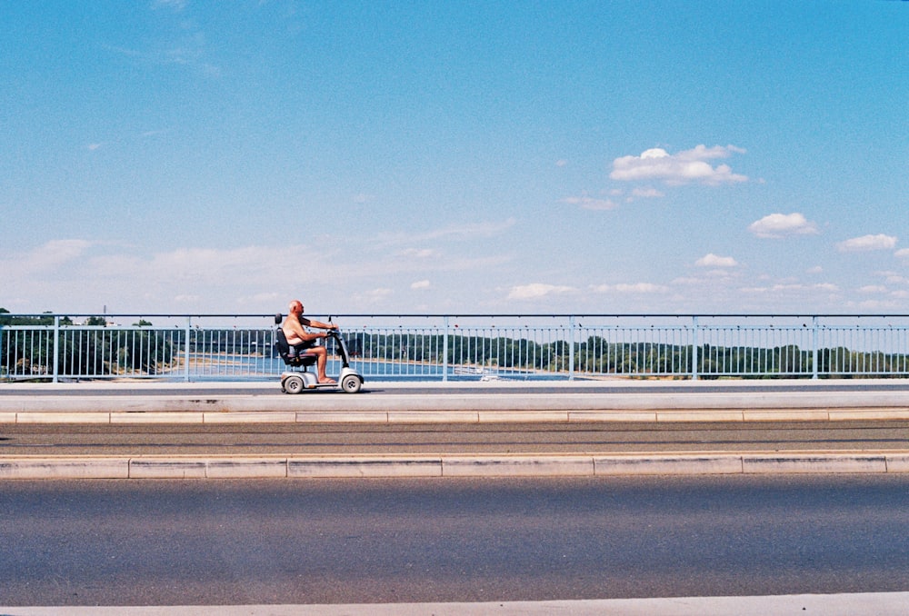 a person riding a tricycle on a road