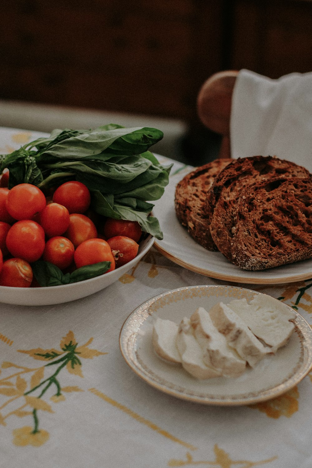 a plate of food and a bowl of fruit on a table