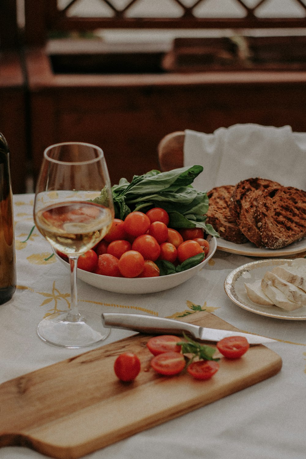 a table with plates of food and glasses of wine