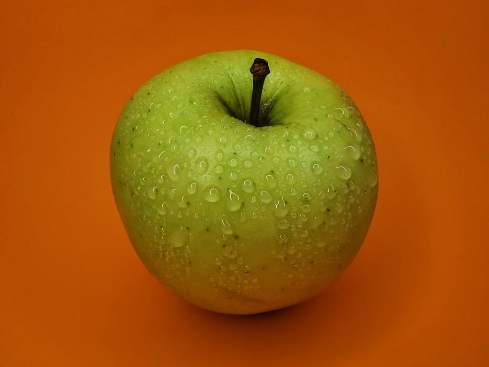 a green apple with a stem