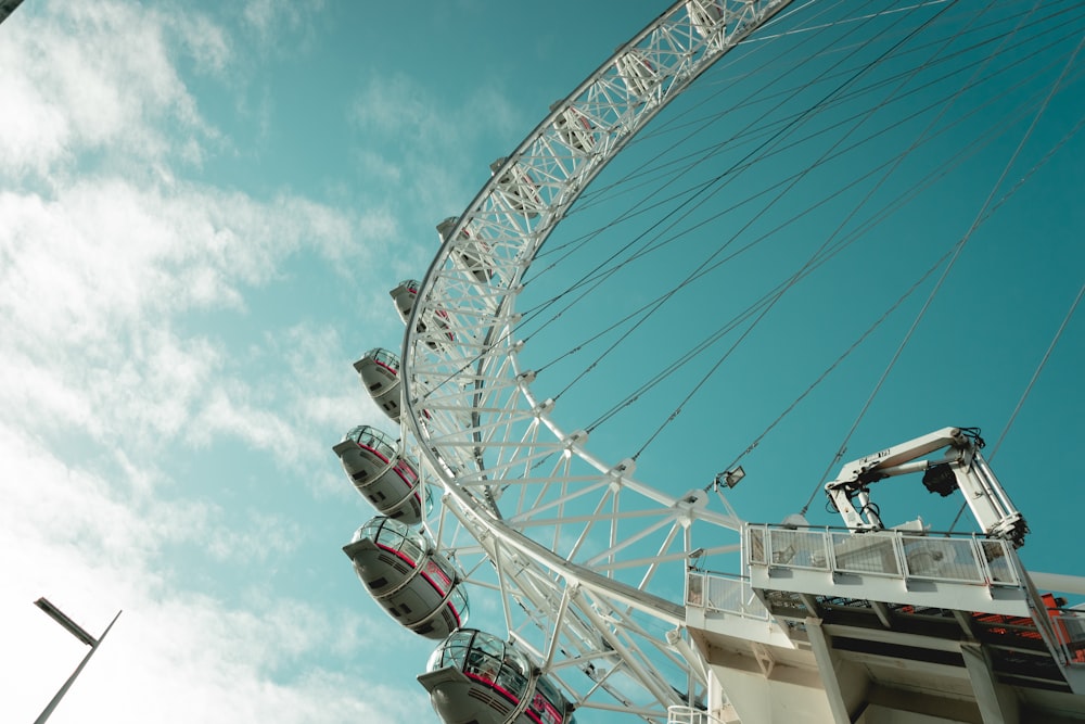 a ferris wheel with blue sky and clouds