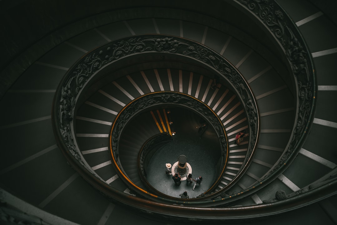 a spiral staircase with people,