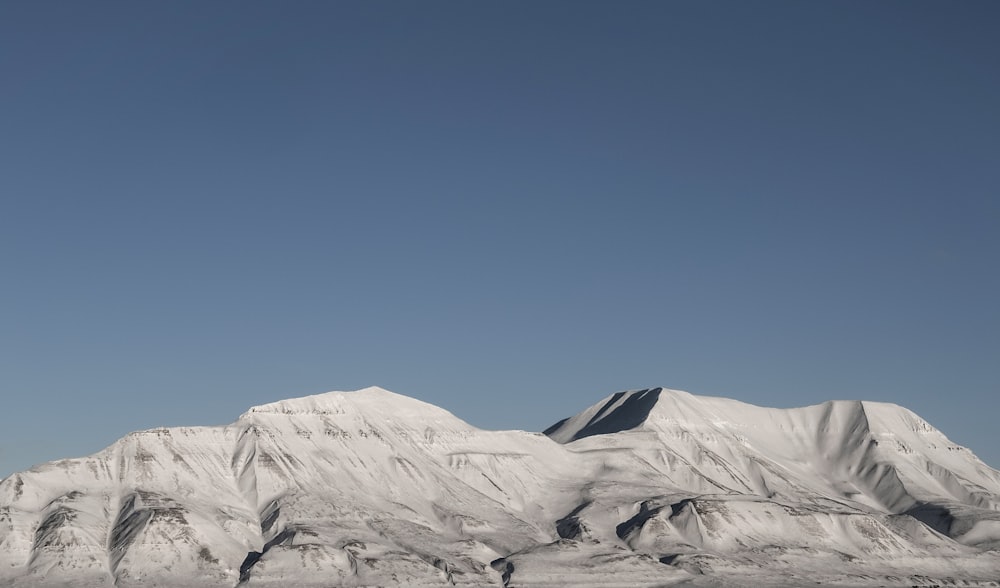 a snowy mountain with blue sky