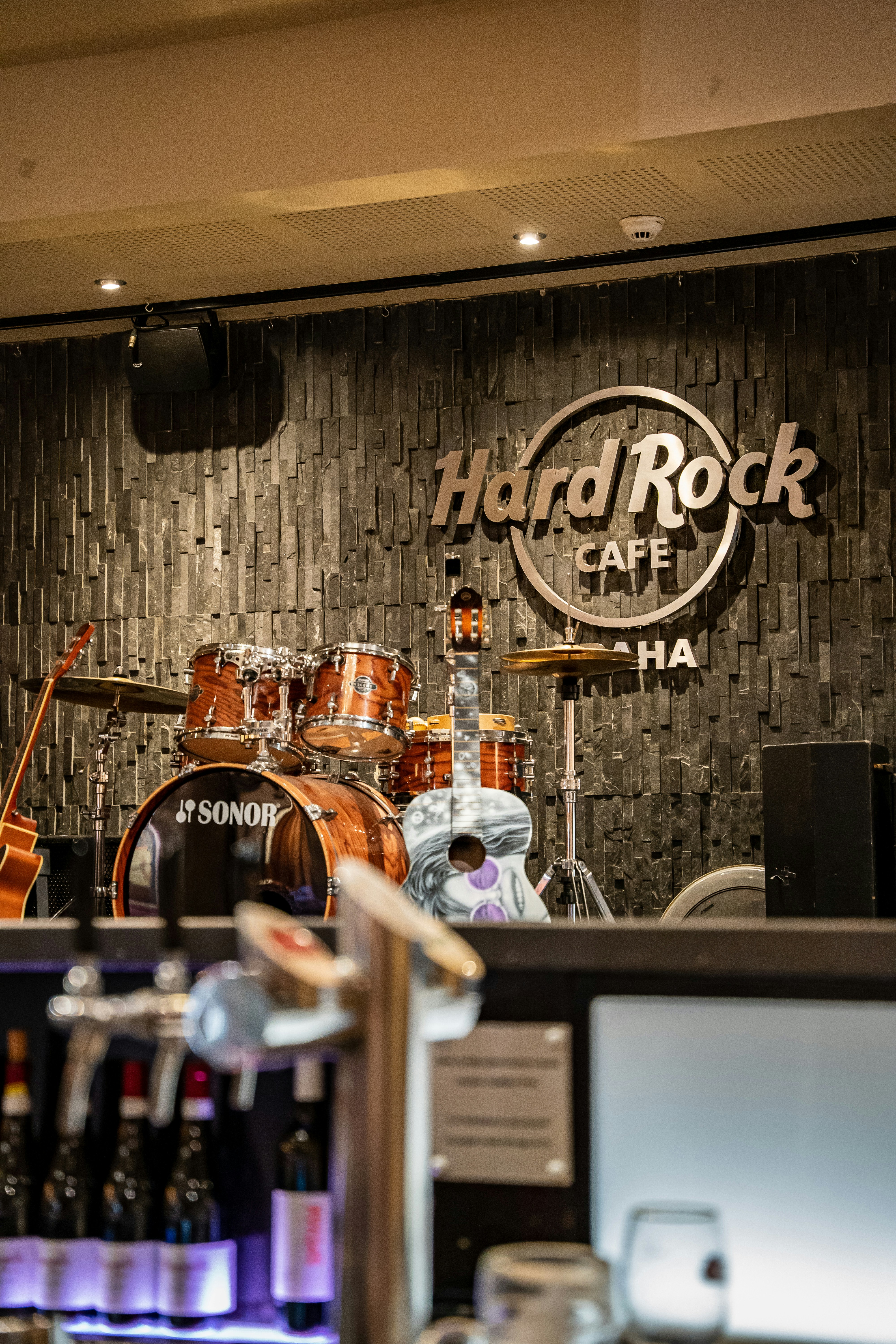 a bar with a sign and wine bottles