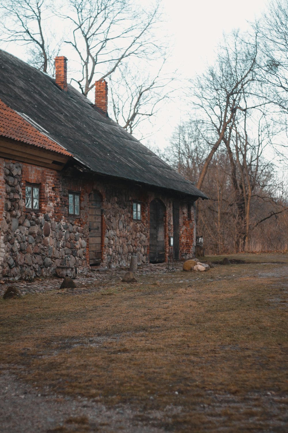 a brick house with a stone wall