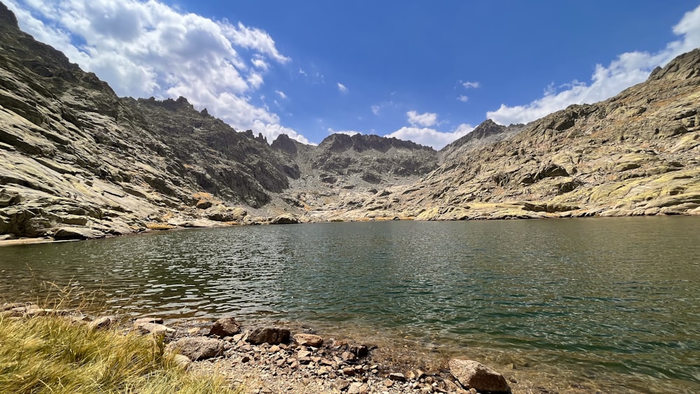 a body of water with mountains in the back