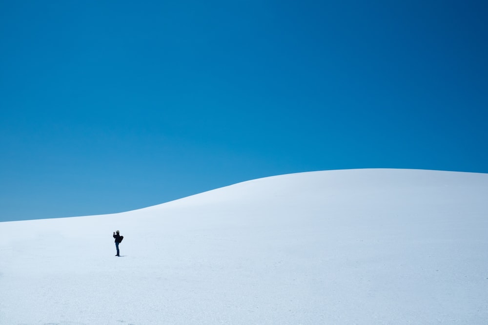 a person walking up a snowy hill