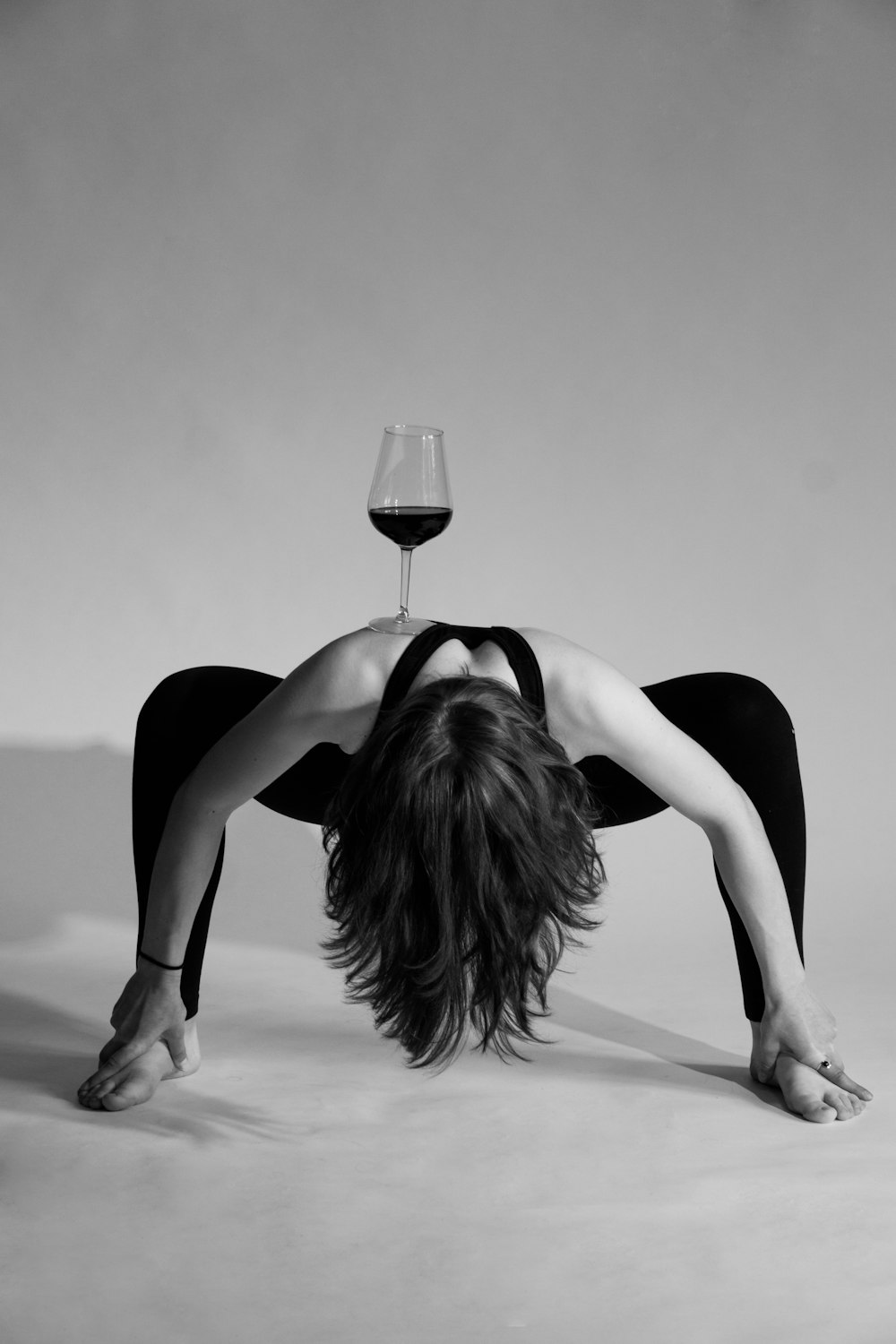 a woman lying on the floor with a glass of wine