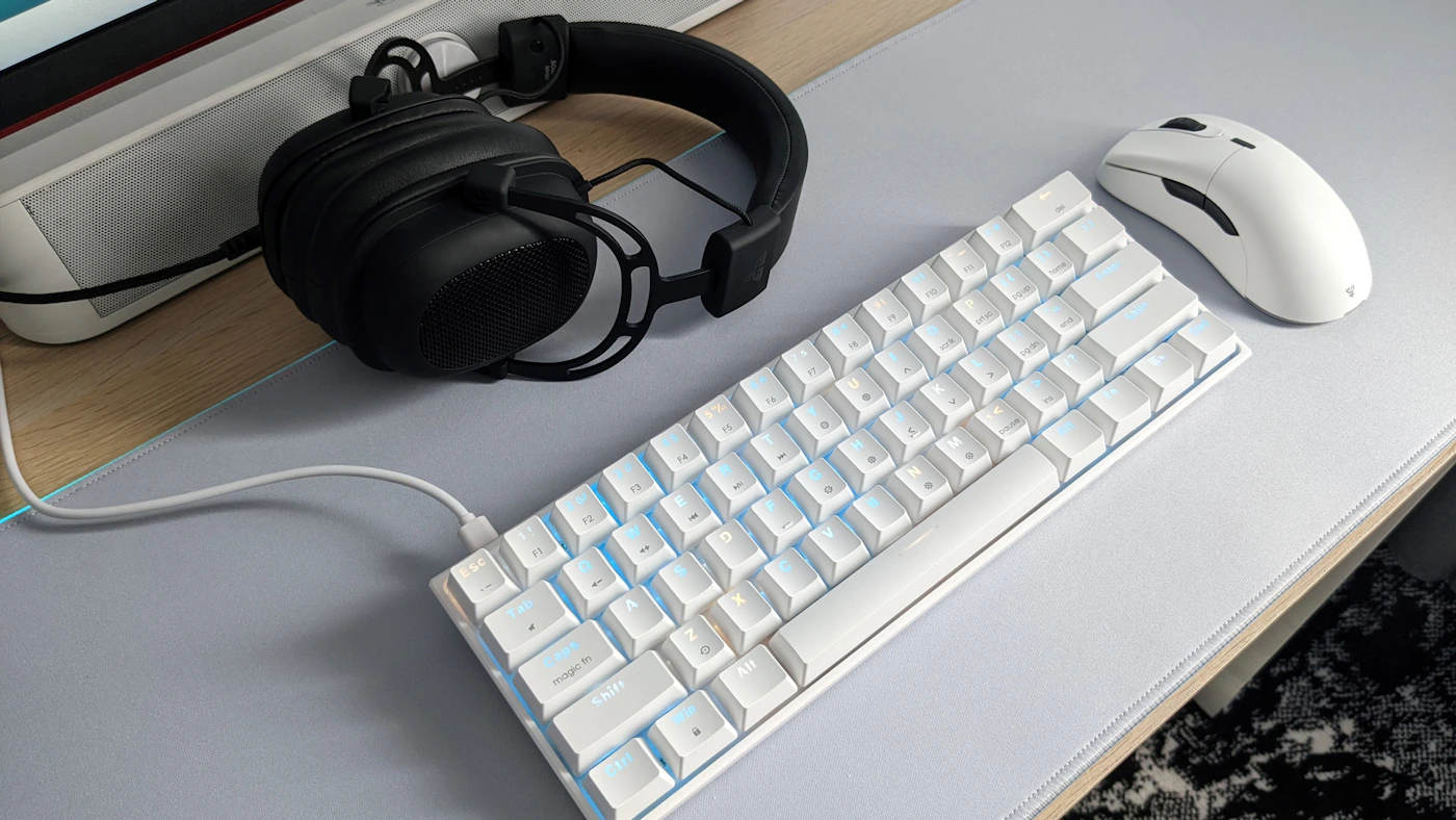 Gaming keyboard, mouse, and headset arranged on a gaming desk