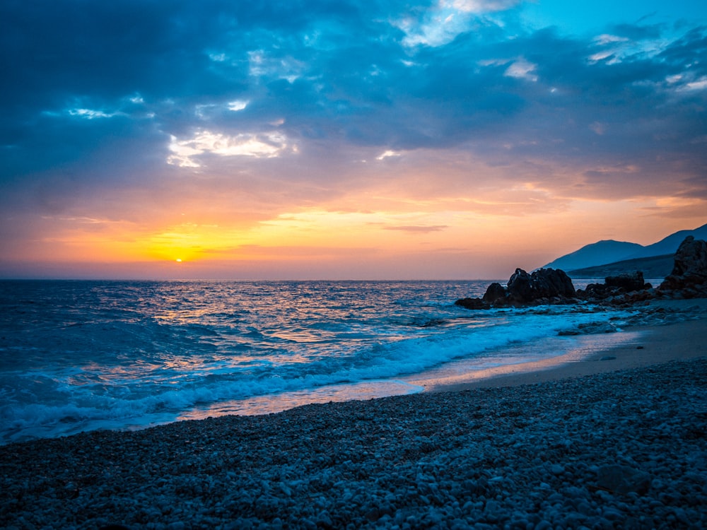 a beach with rocks and water