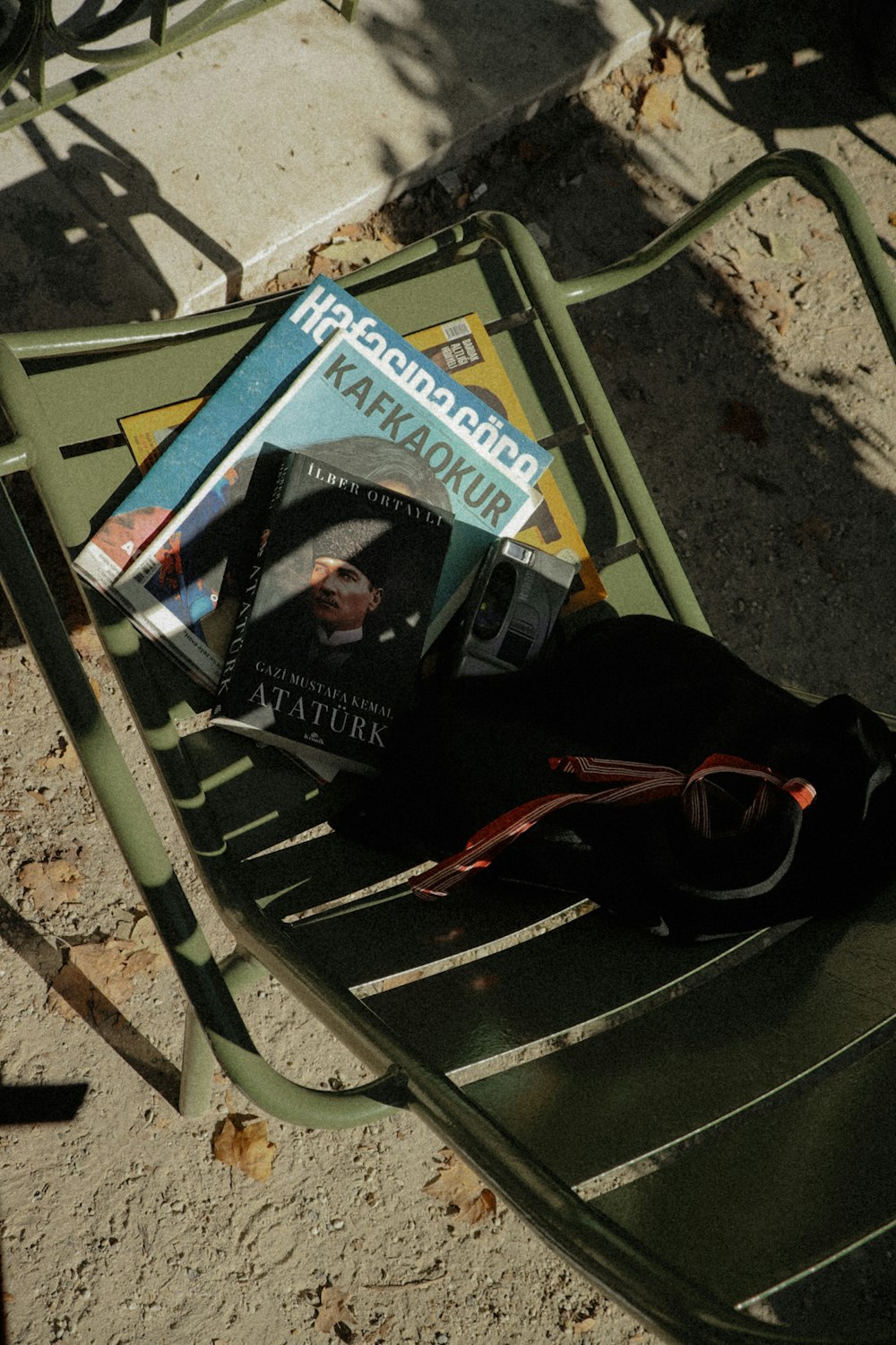 a book and a backpack on a bench
