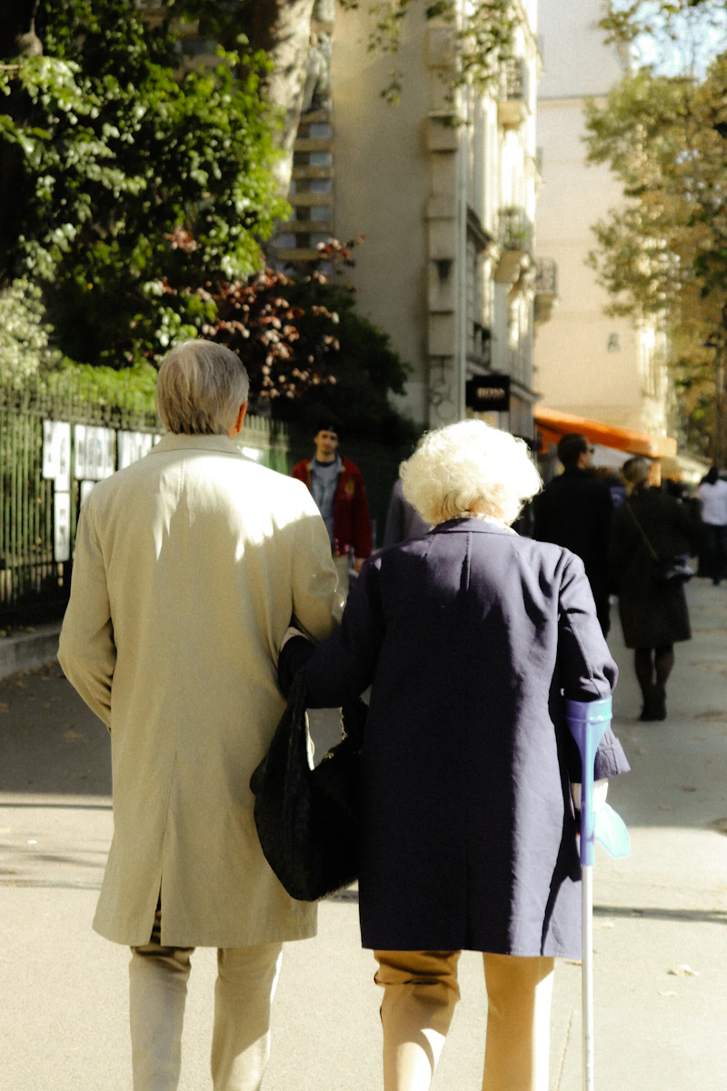 Two people walking side by side along a quiet pavement — placeholder image
