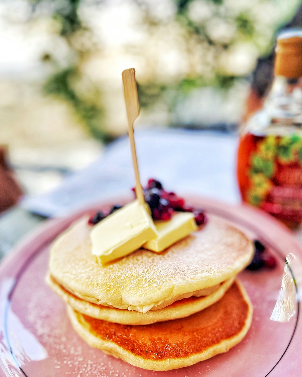 a stack of pancakes with fruit on top