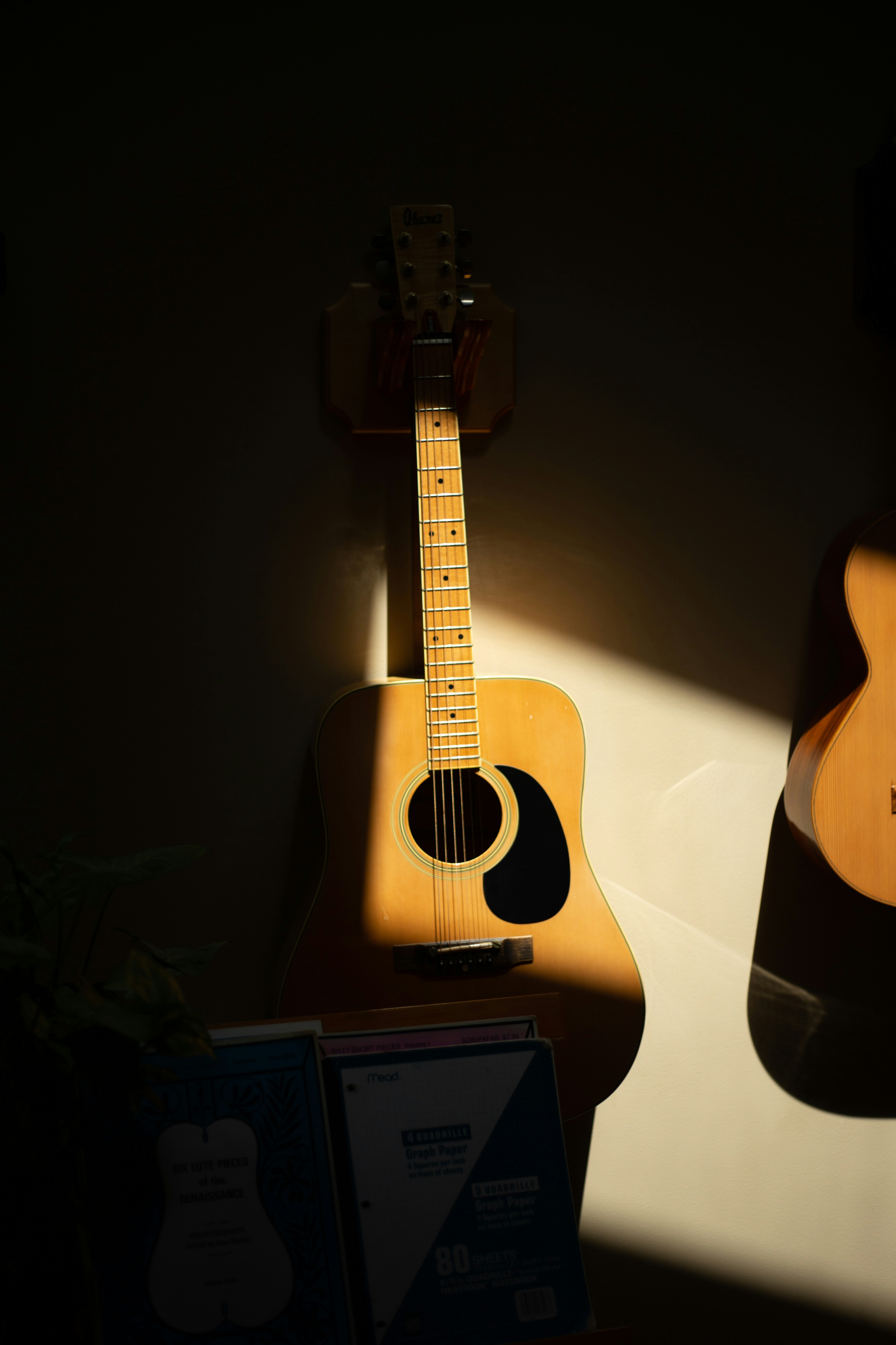 a guitar leaning against a wall
