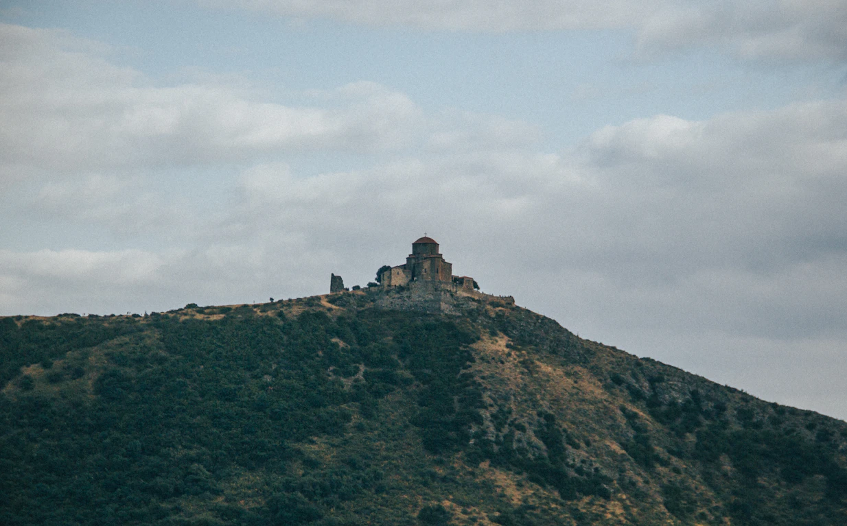 Ancient Georgian monastery on mountain peak