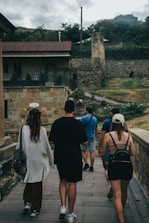 a group of people walking on a stone path