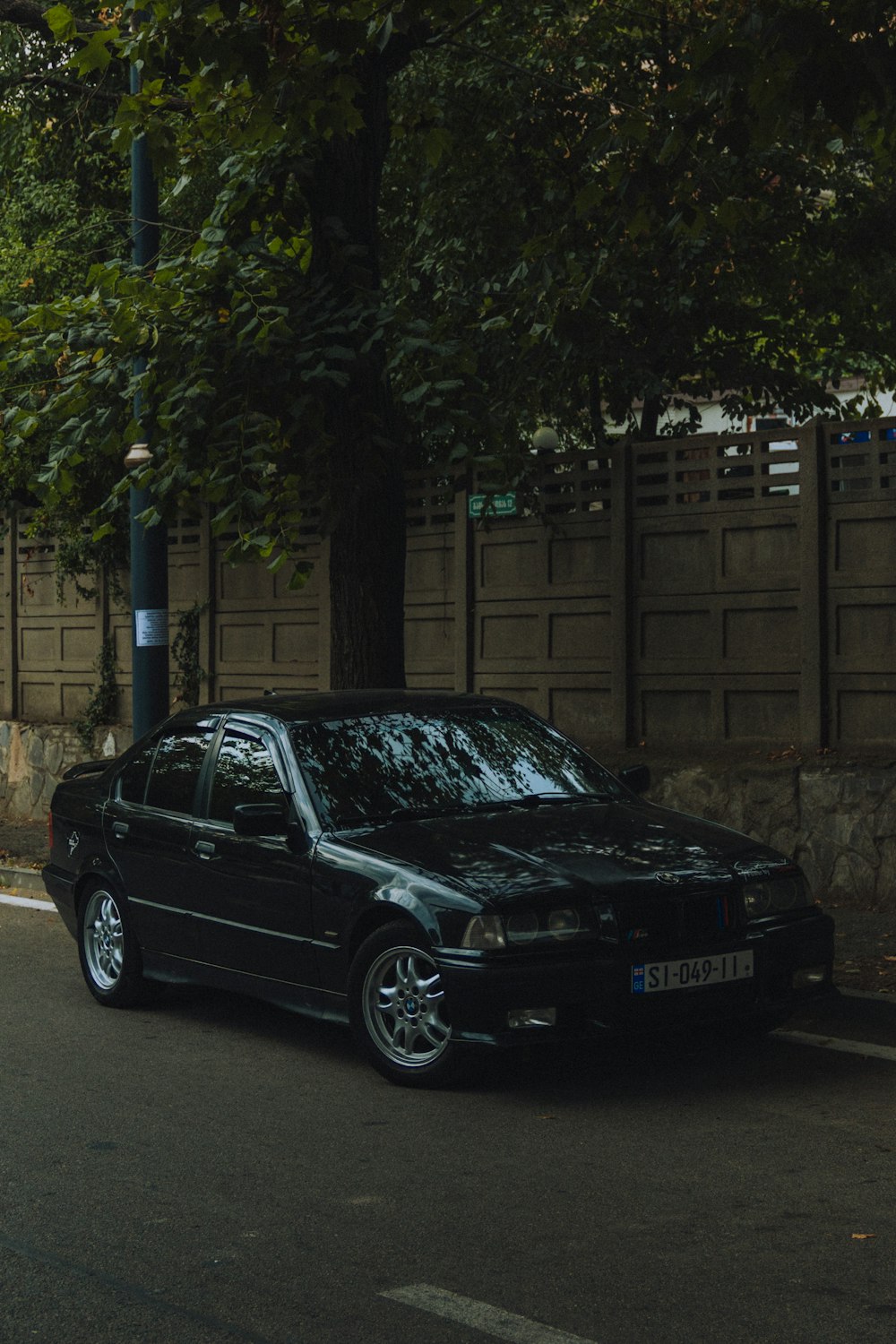 a black car parked on the side of a road